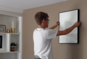 Nate hanging a picture
